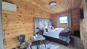 a bedroom with a bed and a wooden wall at Ehringer Hof in Polling