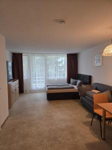 a living room with a bed and a couch at Traumurlaub im Bayerische Wald in Sankt Englmar