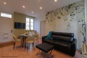 a living room with a couch and a table at Gîtes de france le cosy saint pierre in Sées