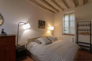 a bedroom with a bed with two pillows on it at Gîtes de france le cosy saint pierre in Sées