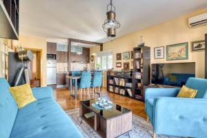 a living room with a blue couch and a table at World Traveler Nest in Kotor
