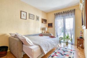 a bedroom with a bed and a couch and a window at World Traveler Nest in Kotor