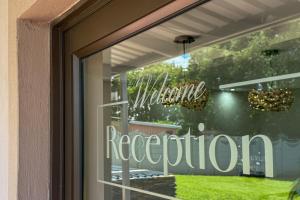 a window with a welcome reception sign on a door at Luxury Heights Bed and Breakfast in Newcastle +45 photos