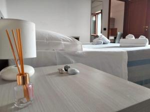 a living room with a bed and a table with a lamp at Afrodite Home in Solfara Mare +10 photos