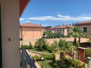 a view of a courtyard with palm trees and buildings at Afrodite Home in Solfara Mare