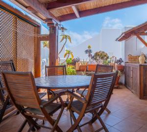 a dining room with a table and chairs on a patio at La terraza de Albatros in La Isleta del Moro
