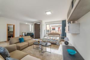 a living room with a couch and a table at Tenuta VillaMar Rooms in Cursi