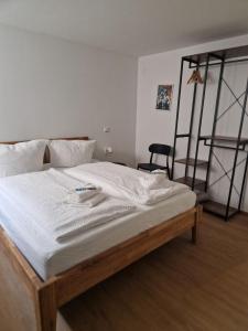 a bedroom with a large bed with white sheets at Huus 17 in Rust