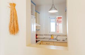 a kitchen with a sink and a mirror at La terraza de Albatros in La Isleta del Moro +11 photos