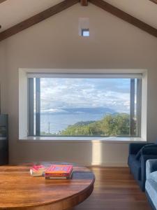 a living room with a large window and a table at Lar do Mar in Beloso