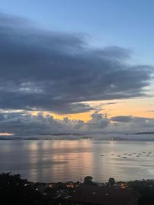 a view of a large body of water at sunset at Lar do Mar in Beloso +3 photos