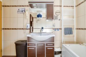 a small bathroom with a sink and a bath tub at World Traveler Nest in Kotor +43 photos