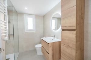 a bathroom with a sink and a toilet and a shower at Casa Ingravita - Oceanfront Tranquility in Cunit +20 photos