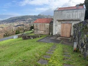 an old stone building on a hill with a yard at Lar do Mar in Beloso