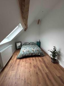 a bedroom with a bed in the corner of a room at L'Echo de la Nature in Sasseville +11 photos