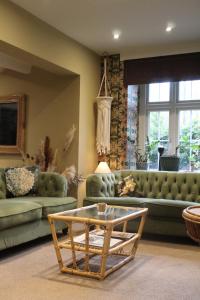 a living room with couches and a coffee table at The Crescent Turner Hotel in Whitstable