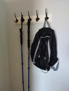two ski poles and a bag hanging on a rack at Casa Adamo 77 in Badolato