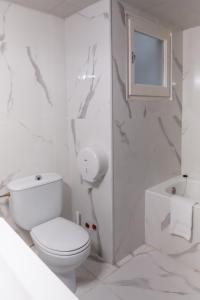 a white bathroom with a toilet and a shower at Hotel Austria by Pierre & Vacances in Soldeu