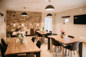 a dining room with wooden tables and chairs at Ca' Perenzin in Tarzo
