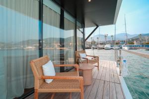 a balcony with chairs and a view of the water at Marina Suite in Loano