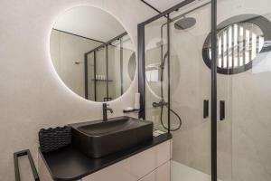 a bathroom with a sink and a mirror at Marina Suite in Loano +5 photos