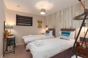 a bedroom with two beds and a window at Lancaster City Apartment in Lancaster +6 photos