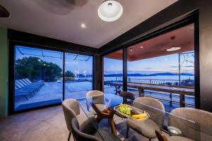 a dining room with a view of the water at Villa sea, sun and fun in Trogir