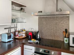 a kitchen with a counter top with a microwave at Sandbourne in Bournemouth