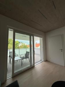 a living room with sliding glass doors and a patio at Ferienwohnung 2 Stock Bad Schallerbach in Bad Schallerbach +2 photos