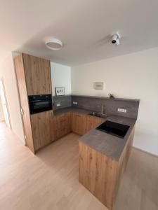 a kitchen with wooden cabinets and a counter top at Ferienwohnung 2 Stock Bad Schallerbach in Bad Schallerbach