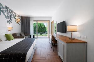 a hotel room with a bed and a desk at Lavi Kibbutz Hotel in Lavi