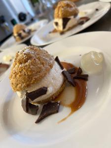 a plate of food with a dessert on a table at Auberge Lou Poumié in Pierlas +24 photos
