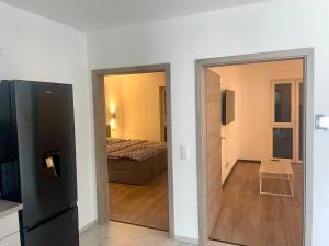 a room with a bed and a door leading to a bedroom at La Casa Motel in Schaafheim