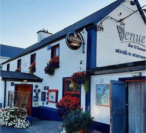 a building with a sign on the side of it at Surfers Getaway - Room Staycation in Sligo