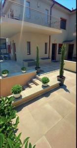 a courtyard with potted plants in front of a building at Myrina Concept in Myrina