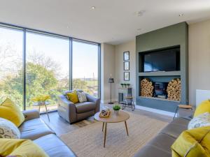 a living room with a couch and a tv at 3 Bed in Belford oc-78057 in Ellington