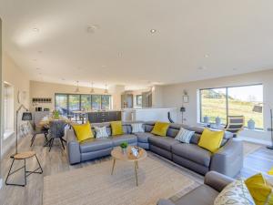 a living room with a gray couch and yellow pillows at 3 Bed in Belford oc-78057 in Ellington