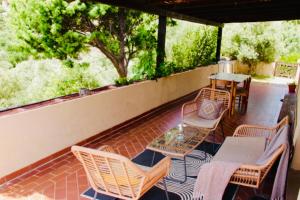 a patio with a table and chairs and a table and chairs at COUNTRY HOUSE HOLIDAY - Olbia in Olbia