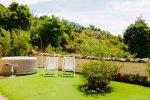 two chairs and a hot tub in a yard at COUNTRY HOUSE HOLIDAY - Olbia in Olbia +12 photos