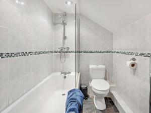 a bathroom with a tub and a toilet and a shower at 3 Bed in Ellesmere oc-94419 in Dodleston +28 photos