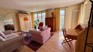 a living room with a couch and chairs and a table at ArtVilla am See - offen März bis Ende Oktober in Radolfzell am Bodensee