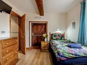 a bedroom with a bed and a dresser and a dresser at 3 Bed in Ellesmere oc-94419 in Dodleston