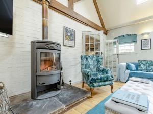 a living room with a wood stove and a couch at 2 Bed in Ashbourne oc-89339 in Edwalton