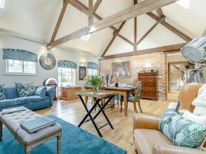 a living room with a blue couch and a table at 2 Bed in Ashbourne oc-89339 in Edwalton