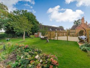 a backyard with a fence and a yard with flowers at 2 Bed in Ashbourne oc-89339 in Edwalton
