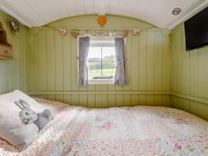 a bedroom with a bed with a bunny pillow and a window at 1 Bed in Hereford oc-79576 in Byford
