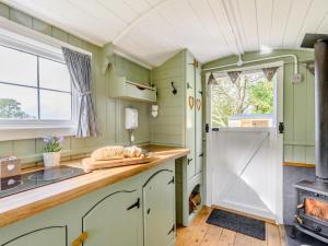 a kitchen with green cabinets and a stove at 1 Bed in Hereford oc-79576 in Byford +12 photos