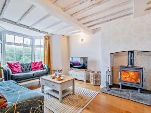 a living room with a fireplace and a couch at 2 Bed in Swindon oc-93489 in Bishopstone