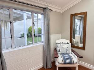 a room with a window with a bench and a mirror at Point Hideaway Mossel Bay in Mossel Bay +23 photos