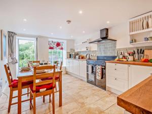 a kitchen with a table and a dining room at 2 Bed in Swindon oc-93489 in Bishopstone